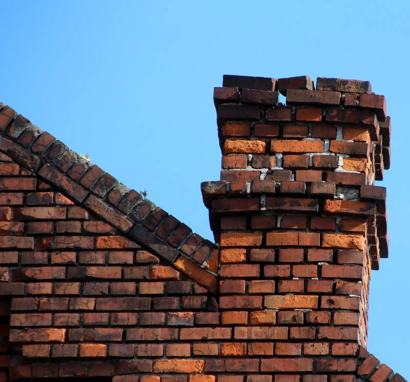 Damaged chimney on an Woodland Hills home showing cracks and missing mortar
